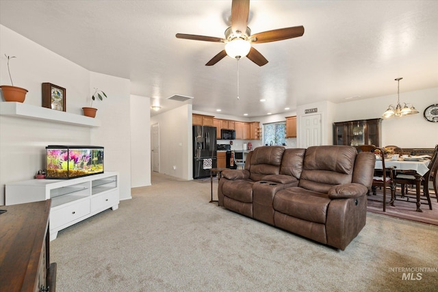 4590 E Stone Falls Dr, Nampa, ID 83686 - living area with light colored carpet, a ceiling fan, and a chandelier