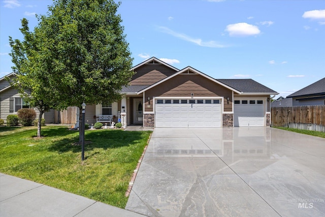 4590 E Stone Falls Dr, Nampa, ID 83686 - craftsman-style house featuring a garage, concrete driveway, stone siding, and covered porch