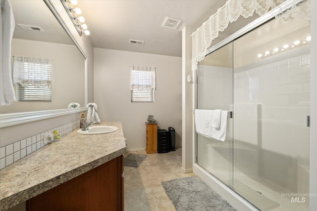 4590 E Stone Falls Dr, Nampa, ID 83686 - bathroom featuring vanity, a stall shower, and baseboards