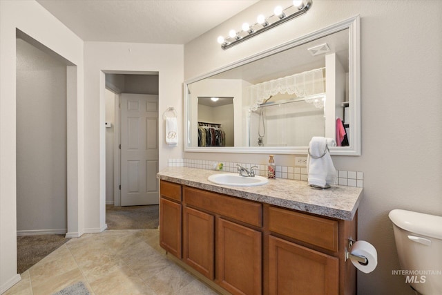4590 E Stone Falls Dr, Nampa, ID 83686 - bathroom with vanity, toilet, and baseboards
