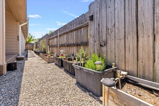 4590 E Stone Falls Dr, Nampa, ID 83686 - fenced backyard featuring a vegetable garden