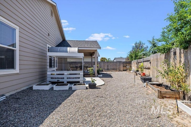 4590 E Stone Falls Dr, Nampa, ID 83686 - fenced backyard featuring a vegetable garden and a patio area