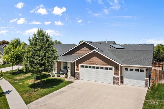 4590 E Stone Falls Dr, Nampa, ID 83686 - craftsman-style house featuring a garage, driveway, solar panels, and stone siding