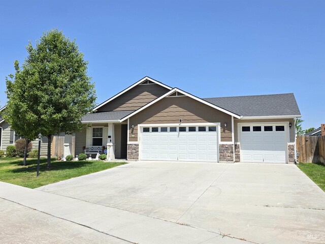 4590 E Stone Falls Dr, Nampa, ID 83686 - craftsman inspired home featuring a garage, driveway, and stone siding