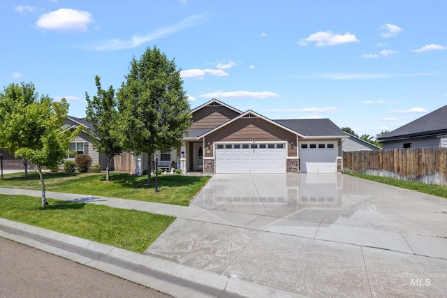 4590 E Stone Falls Dr, Nampa, ID 83686 - view of front of home with concrete driveway, a garage, and stone siding