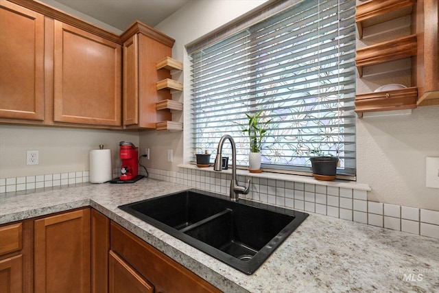 4590 E Stone Falls Dr, Nampa, ID 83686 - kitchen with a sink, light countertops, decorative backsplash, and brown cabinetry