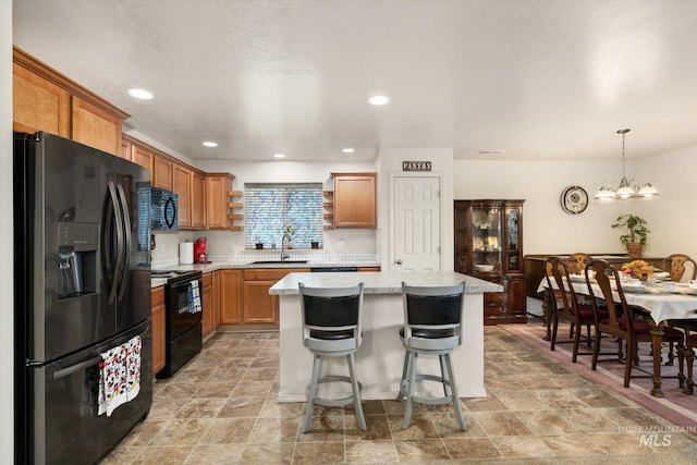 4590 E Stone Falls Dr, Nampa, ID 83686 - kitchen featuring black appliances, open shelves, a sink, a center island, and brown cabinets