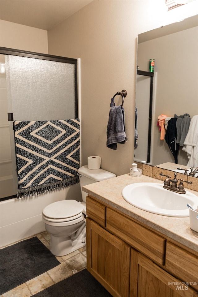 full bathroom with toilet, vanity, and shower / bath combination with glass door