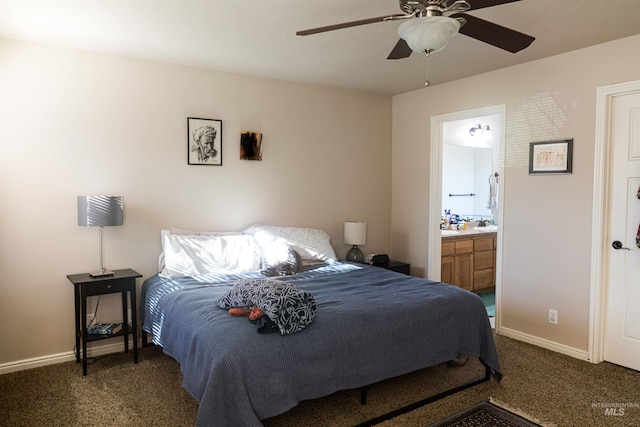 bedroom featuring dark colored carpet, ceiling fan, and connected bathroom