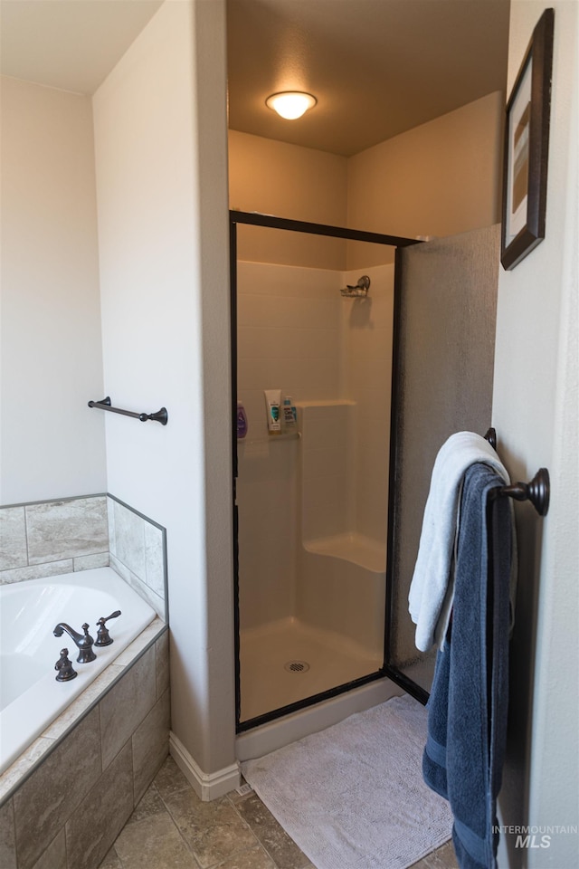 bathroom with separate shower and tub and tile patterned floors