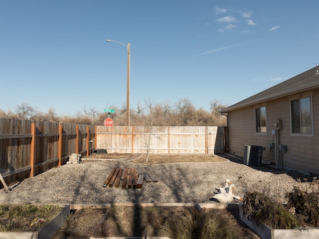 view of yard featuring central air condition unit