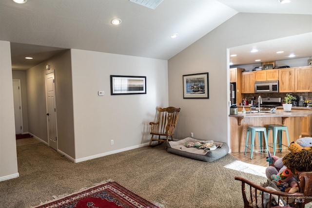 carpeted living room with vaulted ceiling