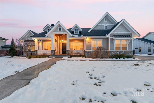 craftsman house with stone siding and a porch