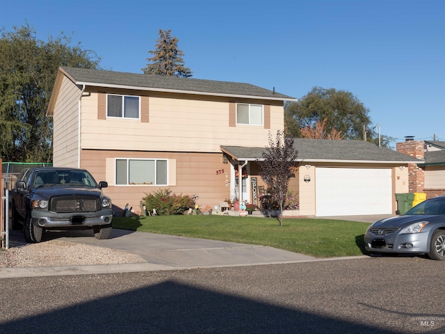 front of property with a front lawn and a garage