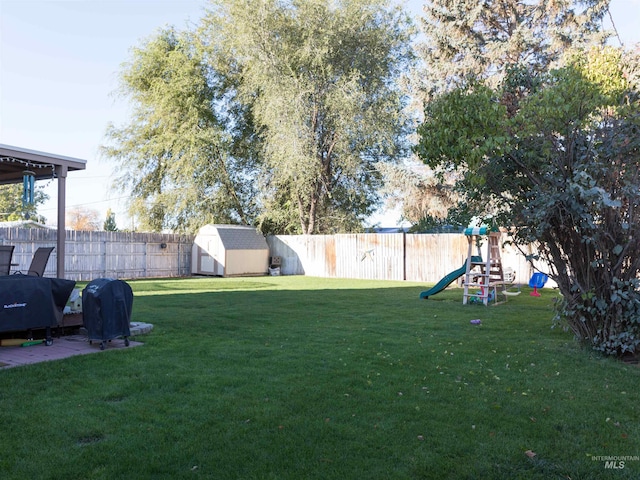 view of yard with a shed and a playground