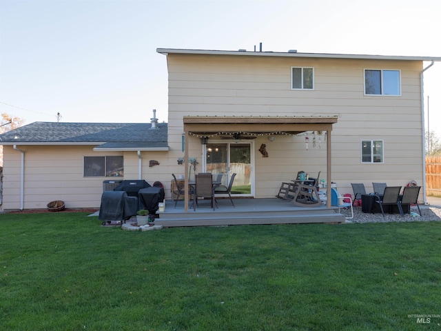 rear view of property with a lawn