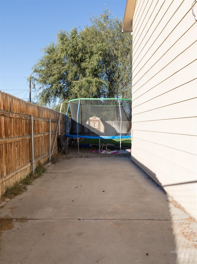 view of yard with a patio and a trampoline