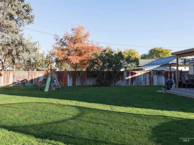 view of yard featuring a playground and a wooden deck