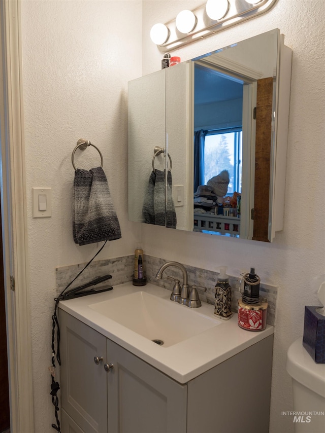 bathroom with toilet and vanity