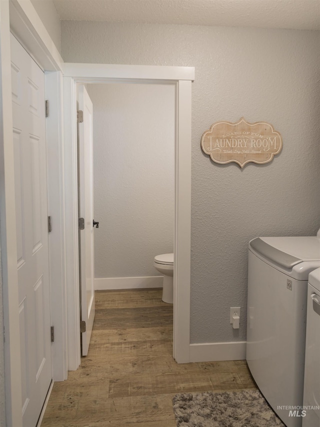 washroom with washer and dryer and hardwood / wood-style flooring