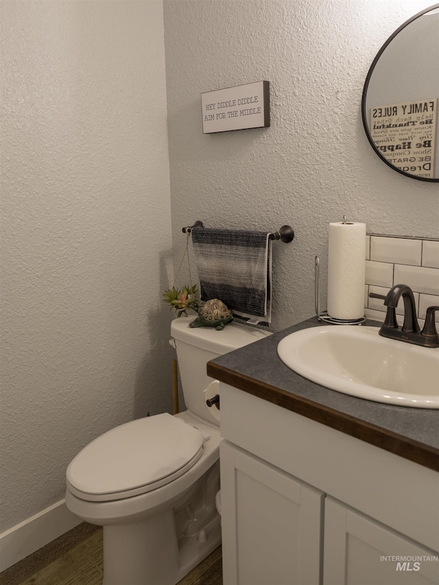 bathroom featuring vanity, toilet, and wood-type flooring