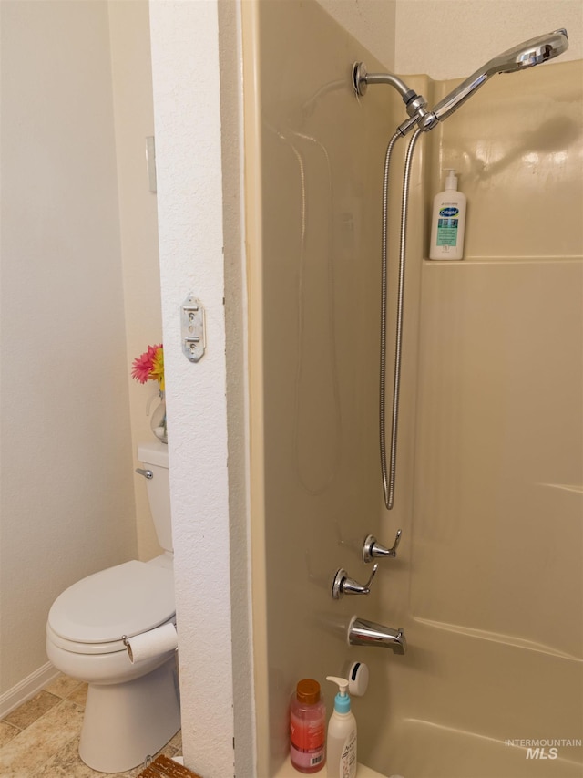 bathroom with toilet and bathtub / shower combination