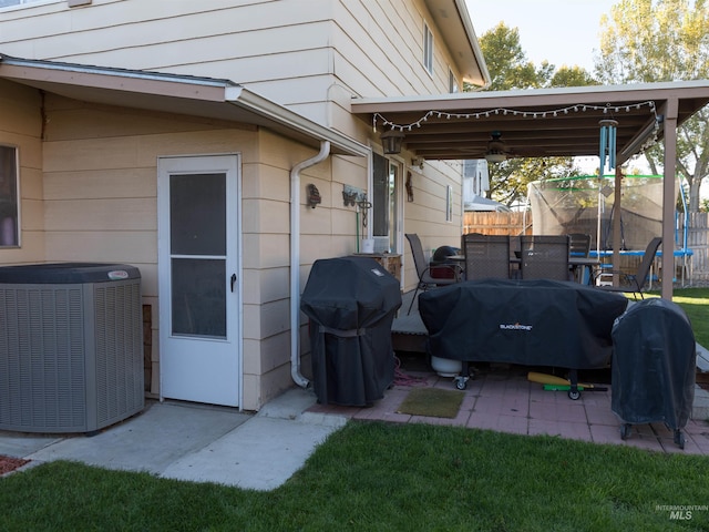 view of patio with cooling unit and a grill