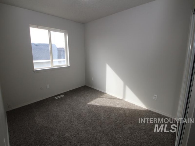 empty room featuring carpet and visible vents