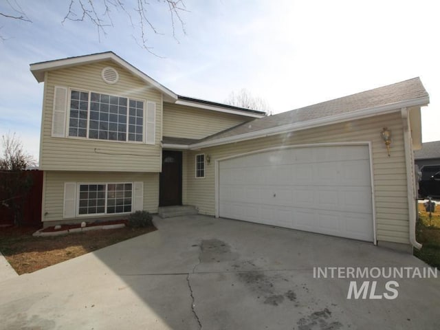 split level home with a garage and driveway