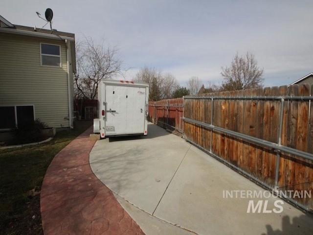 view of patio / terrace with a storage shed, a fenced backyard, and an outdoor structure