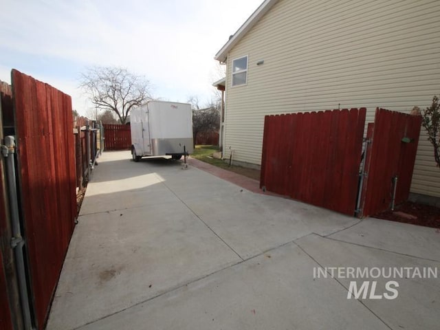 view of side of home featuring fence