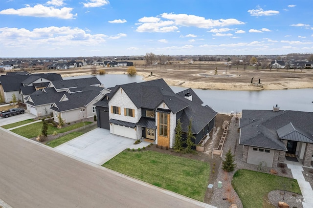 birds eye view of property featuring a residential view and a water view