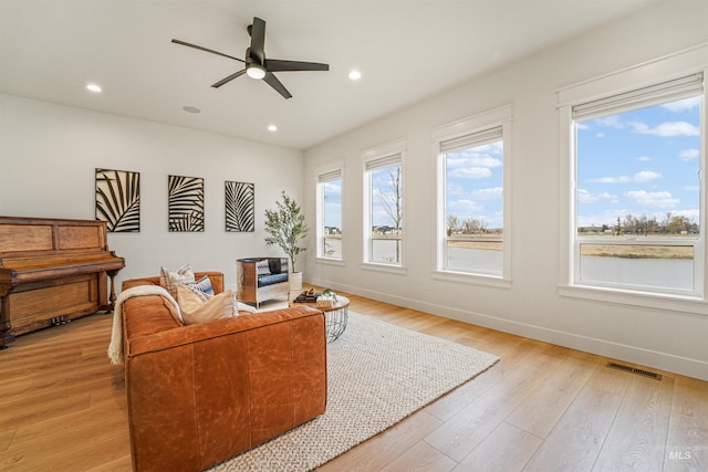 living area featuring visible vents, recessed lighting, light wood finished floors, baseboards, and ceiling fan