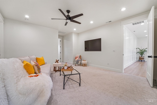 living area featuring recessed lighting, visible vents, light carpet, and baseboards