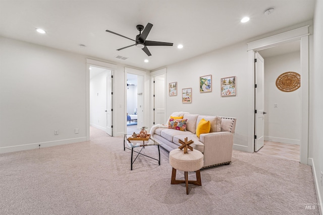 carpeted living room featuring a ceiling fan, recessed lighting, visible vents, and baseboards