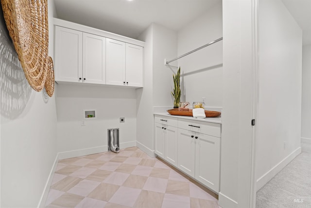 laundry room featuring cabinet space, electric dryer hookup, baseboards, and washer hookup