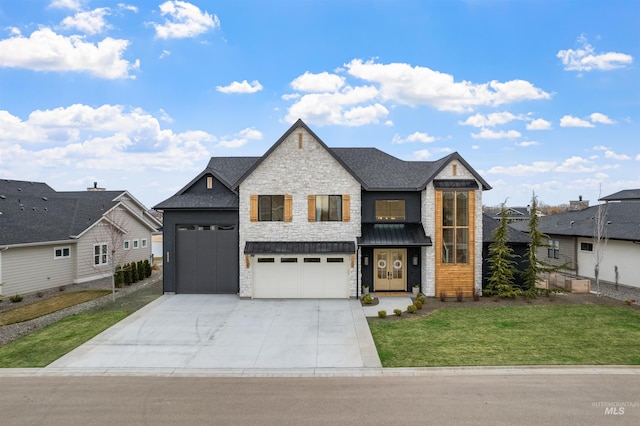 view of front of house with a front yard, stone siding, and driveway