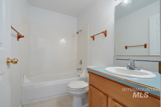 full bathroom with decorative backsplash, toilet, shower / tub combination, and vanity