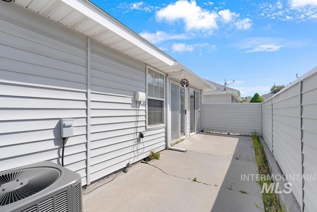 view of patio / terrace with central air condition unit and a fenced backyard