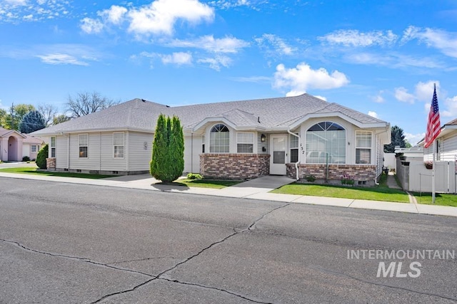 single story home with fence, roof with shingles, and brick siding