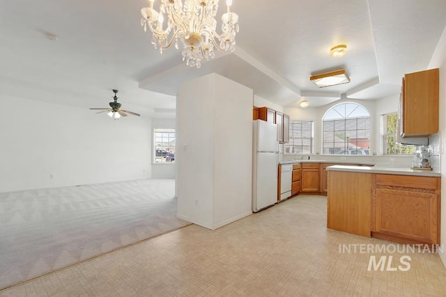 kitchen featuring plenty of natural light, open floor plan, white appliances, and light countertops