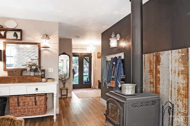 bathroom with hardwood / wood-style floors, french doors, and a wood stove