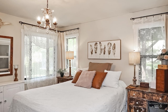 bedroom featuring a notable chandelier