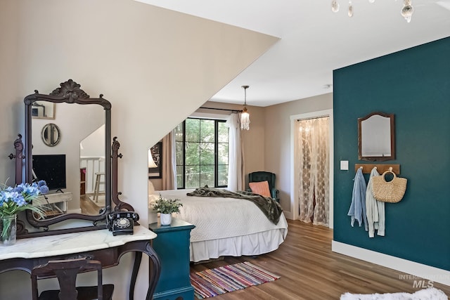 bedroom with dark hardwood / wood-style flooring