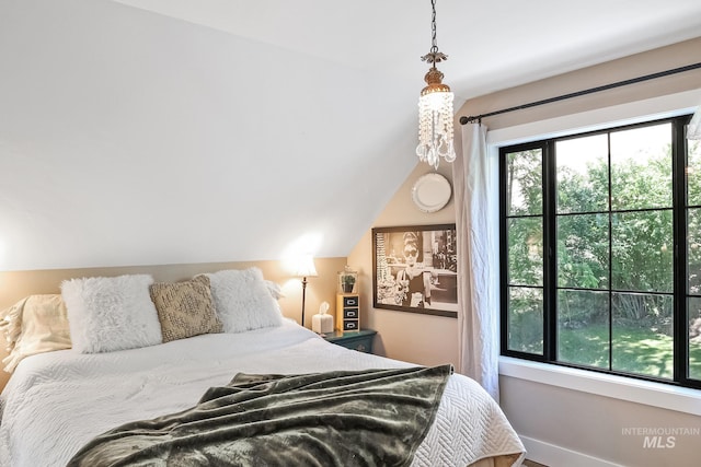 bedroom with multiple windows and vaulted ceiling