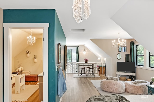 interior space with light hardwood / wood-style flooring and a notable chandelier