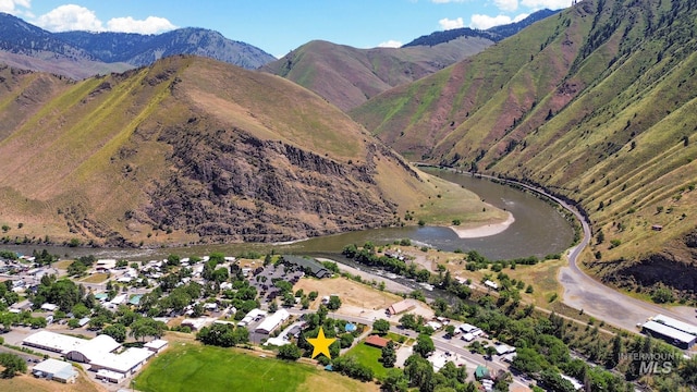 drone / aerial view featuring a water and mountain view