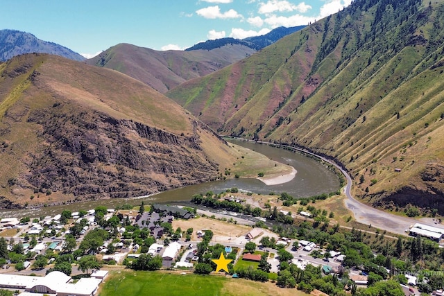 aerial view featuring a water and mountain view