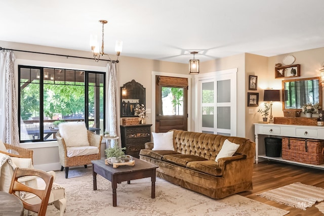 living room featuring a notable chandelier and hardwood / wood-style flooring