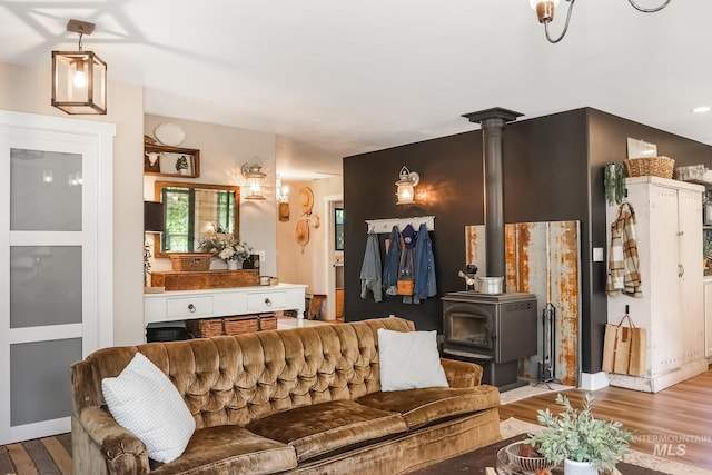 living room with a wood stove and light hardwood / wood-style floors